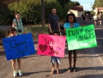 Kids cheering on runners with their signs